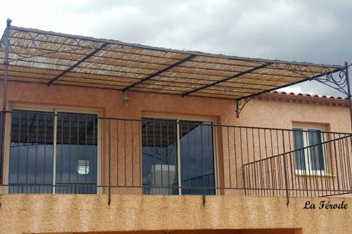Pergola sous forme de pente en fer forgé décor volute à Valence